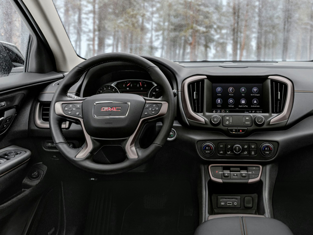 The steering wheel and front dashboard of a GMC vehicle
