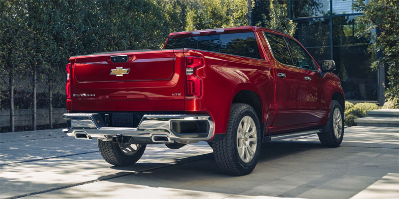 Red Chevrolet Silverado 1500 pickup parked driveway